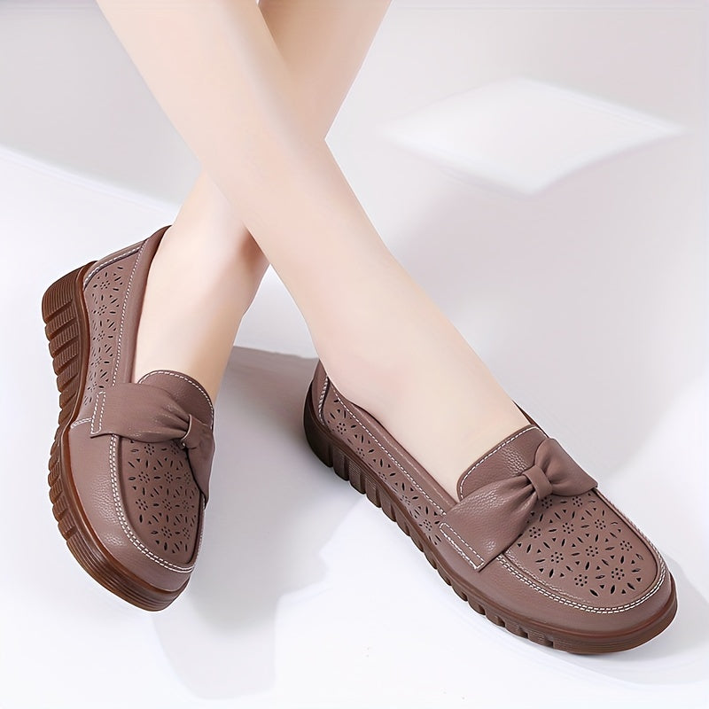 Flat loafers for women with hollow out design, bow detail, soft sole, suitable for casual walking.