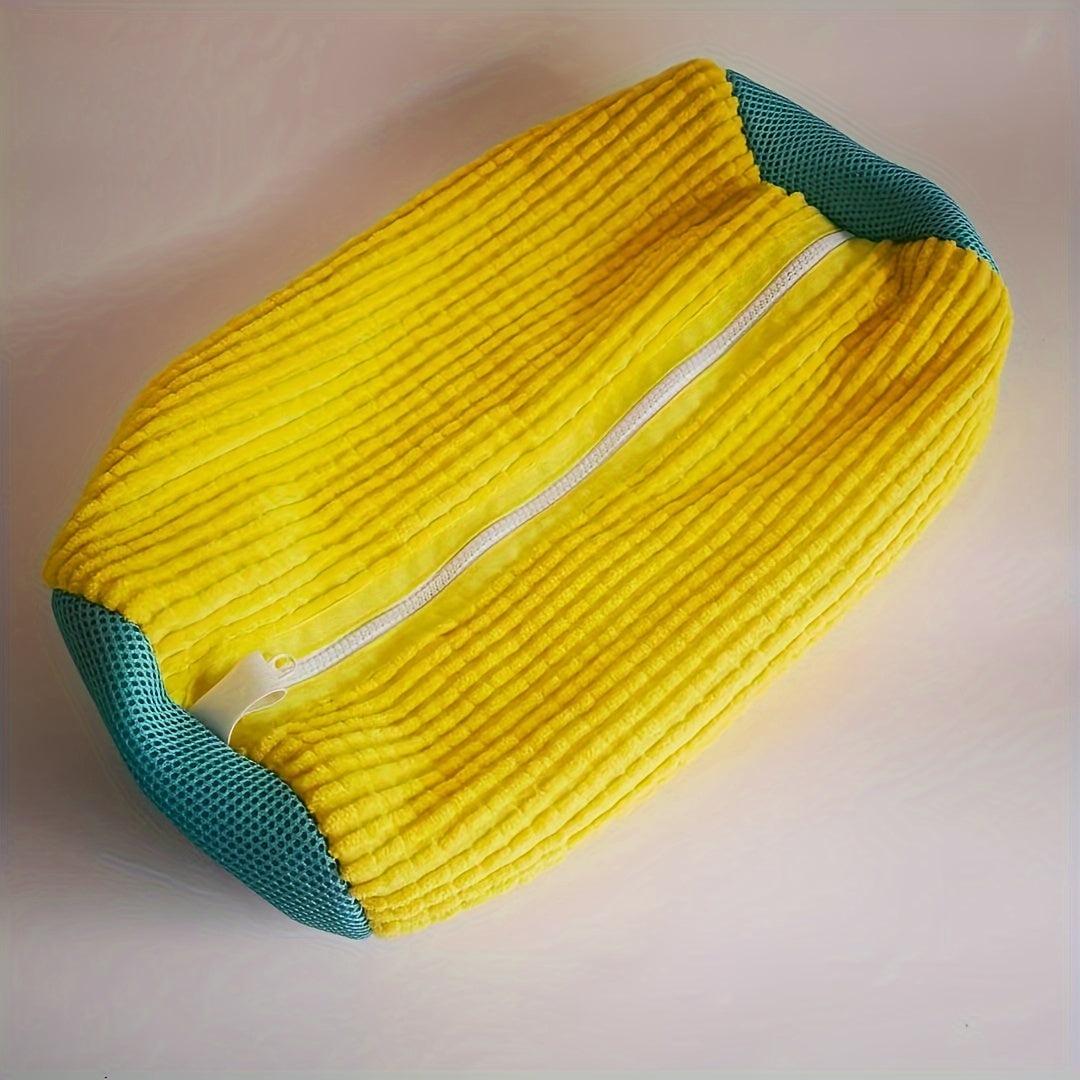 Yellow and teal zippered shoe wash bag for convenient laundry care of sneakers. Made of anti-deformation polyester with a mesh bottom and oval shape. Perfect for keeping your shoes clean and protected during the laundry process.