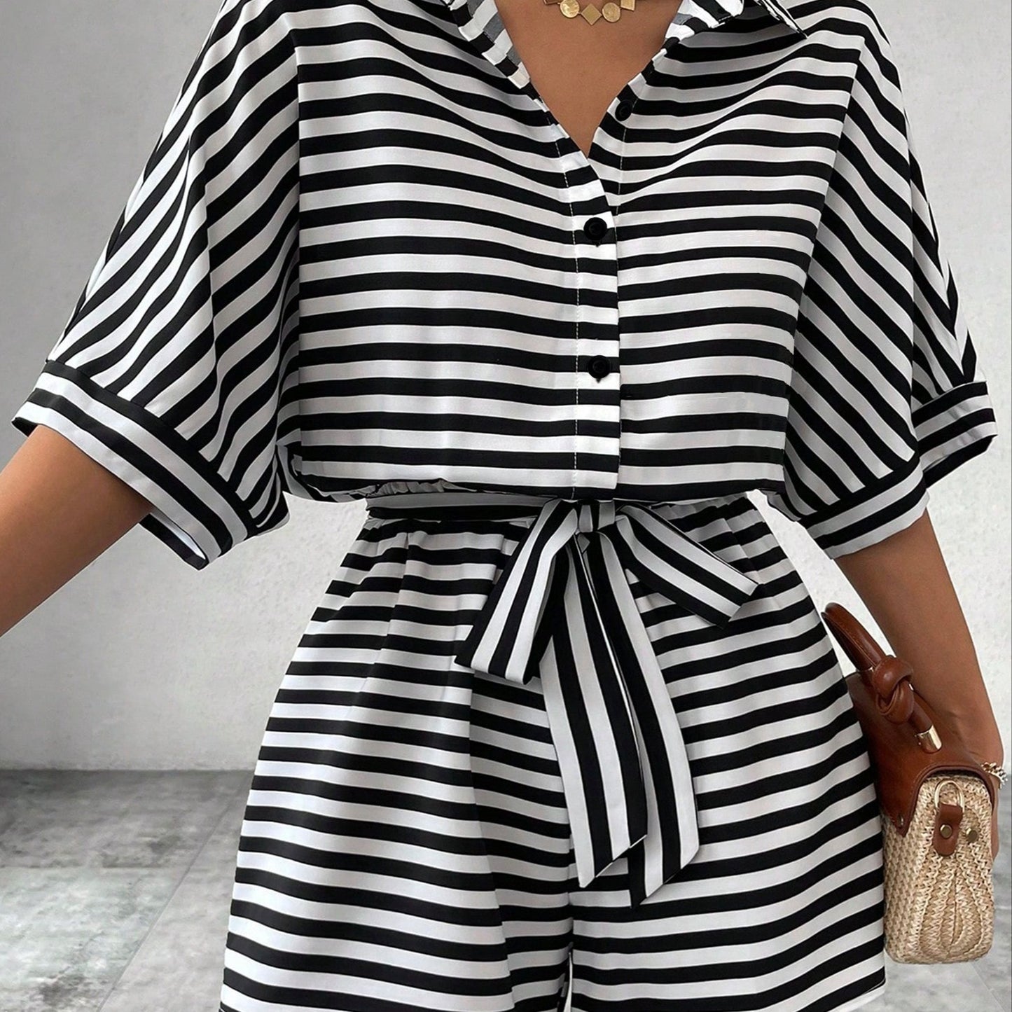 Button front romper jumpsuit with stripes, belt, short sleeves for spring and summer.