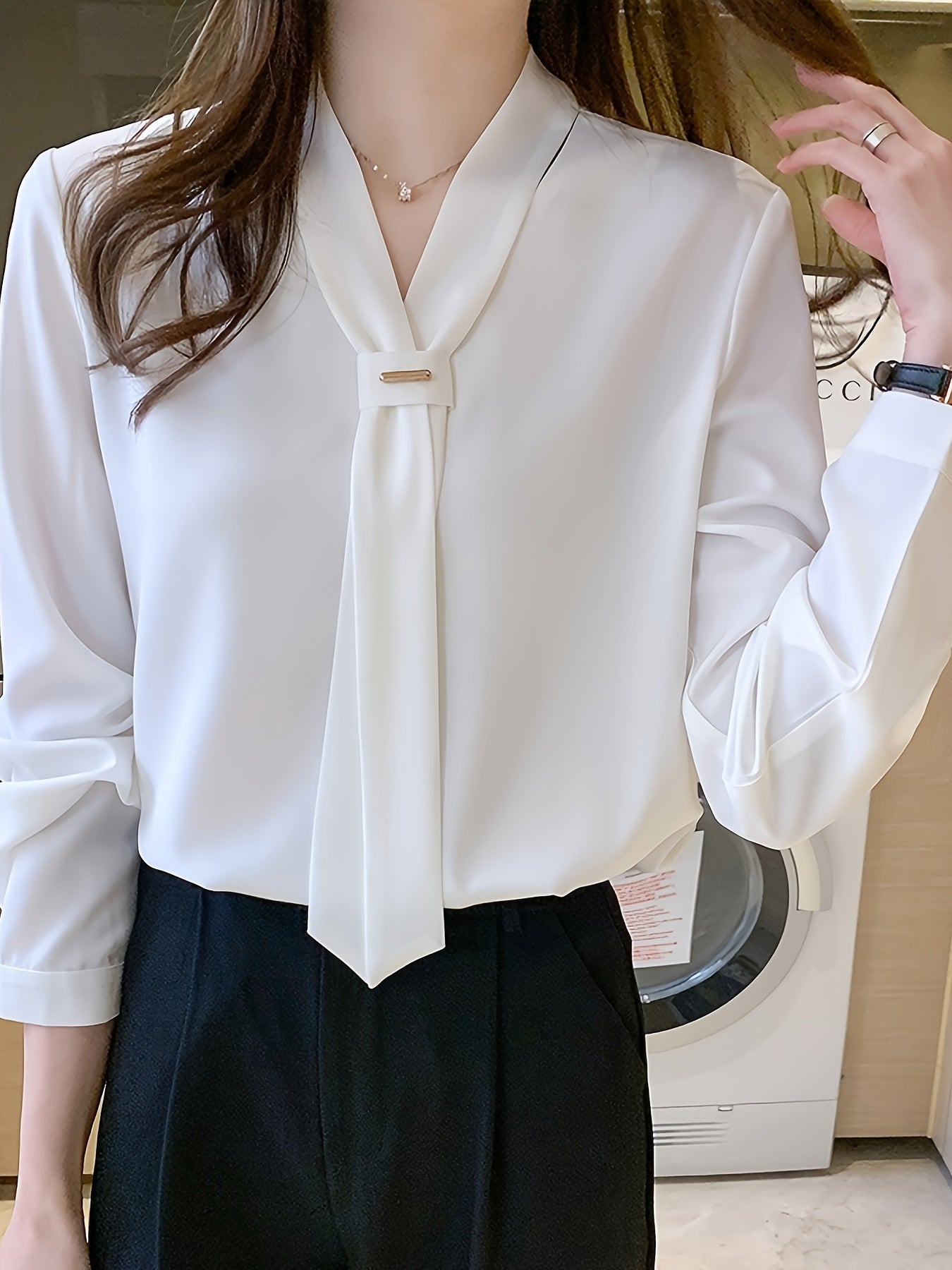 Slimming white chiffon blouse with tie-neck design, perfect for work or casual wear.