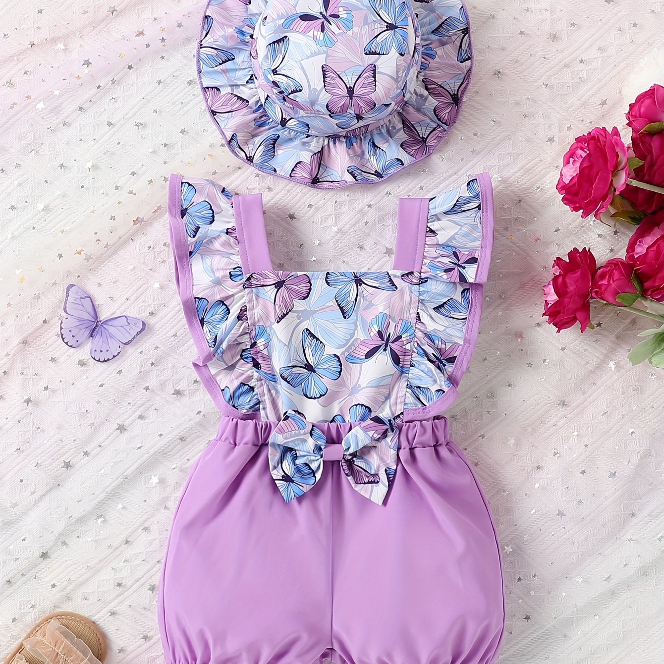 Cute sunflower and butterfly print baby girl jumpsuit with bow detail and matching hat. Made of polyester, machine washable. Perfect for summer and outdoor activities.