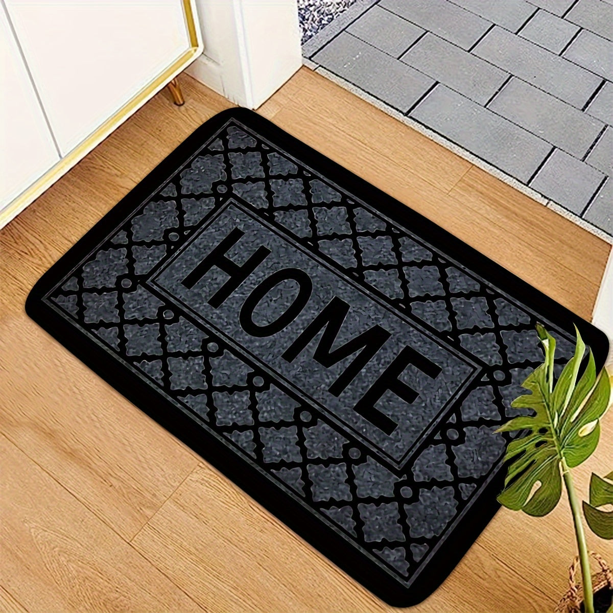 This kitchen flooring mat features a striking black foam design with irregular stripes and the word "HOME" pattern. Made of soft, thick flannel material, this non-slip mat is constructed from 1.2 foam sponge, making it ideal for bathroom and indoor