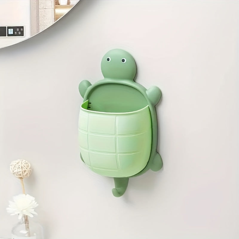 Turtle-shaped wall-mounted remote control holder with self-adhesive storage for home bathroom makeup organization.