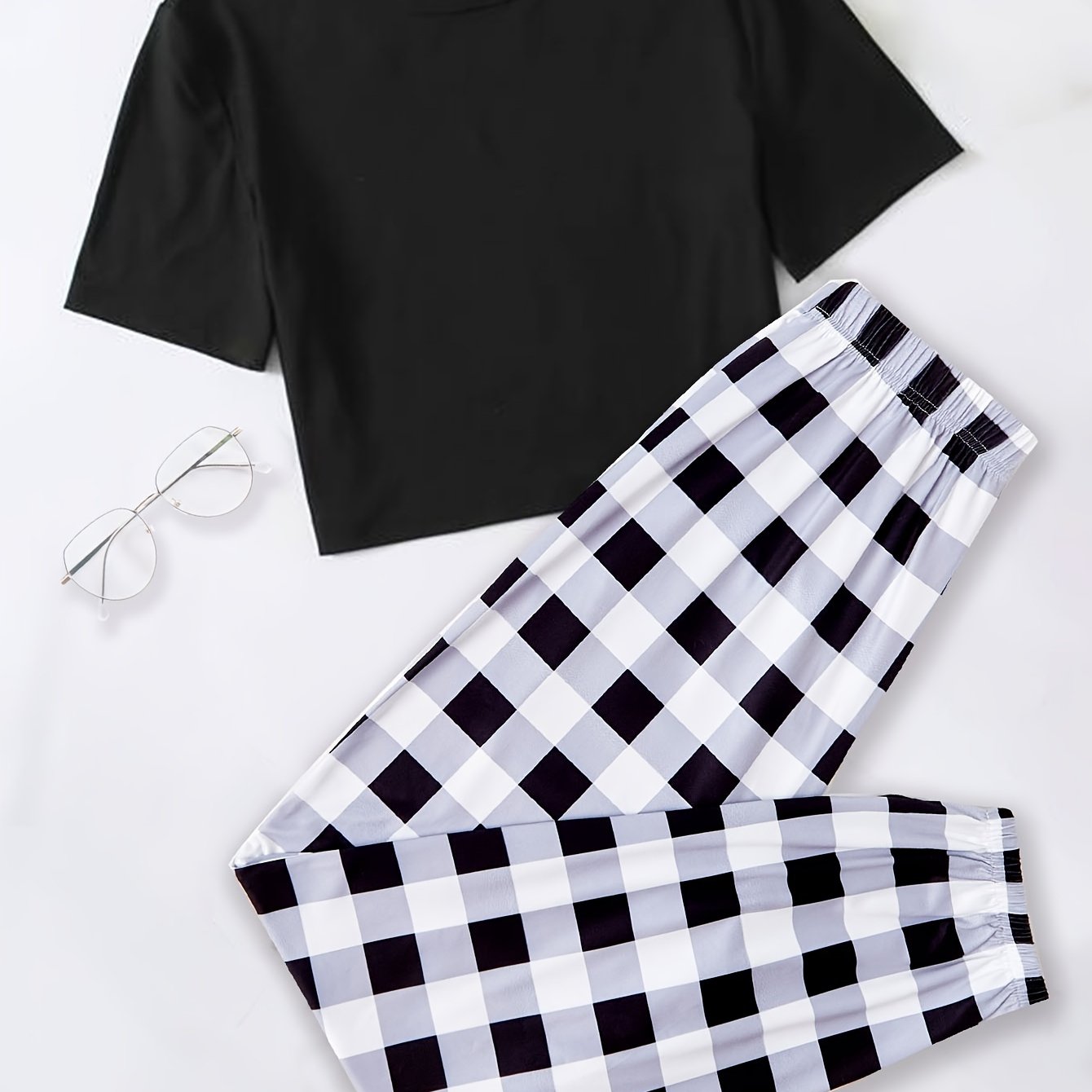 Plaid pajama set for women featuring a short sleeve top and elastic waistband pants.