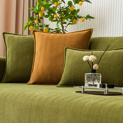 Green chenille sofa cover with herringbone pattern, non-slip and pet-friendly. Fits single to four-seater sofas. Machine washable polyester blend for sofa protection and enhancement. Ideal for living room, bedroom, or office decor.