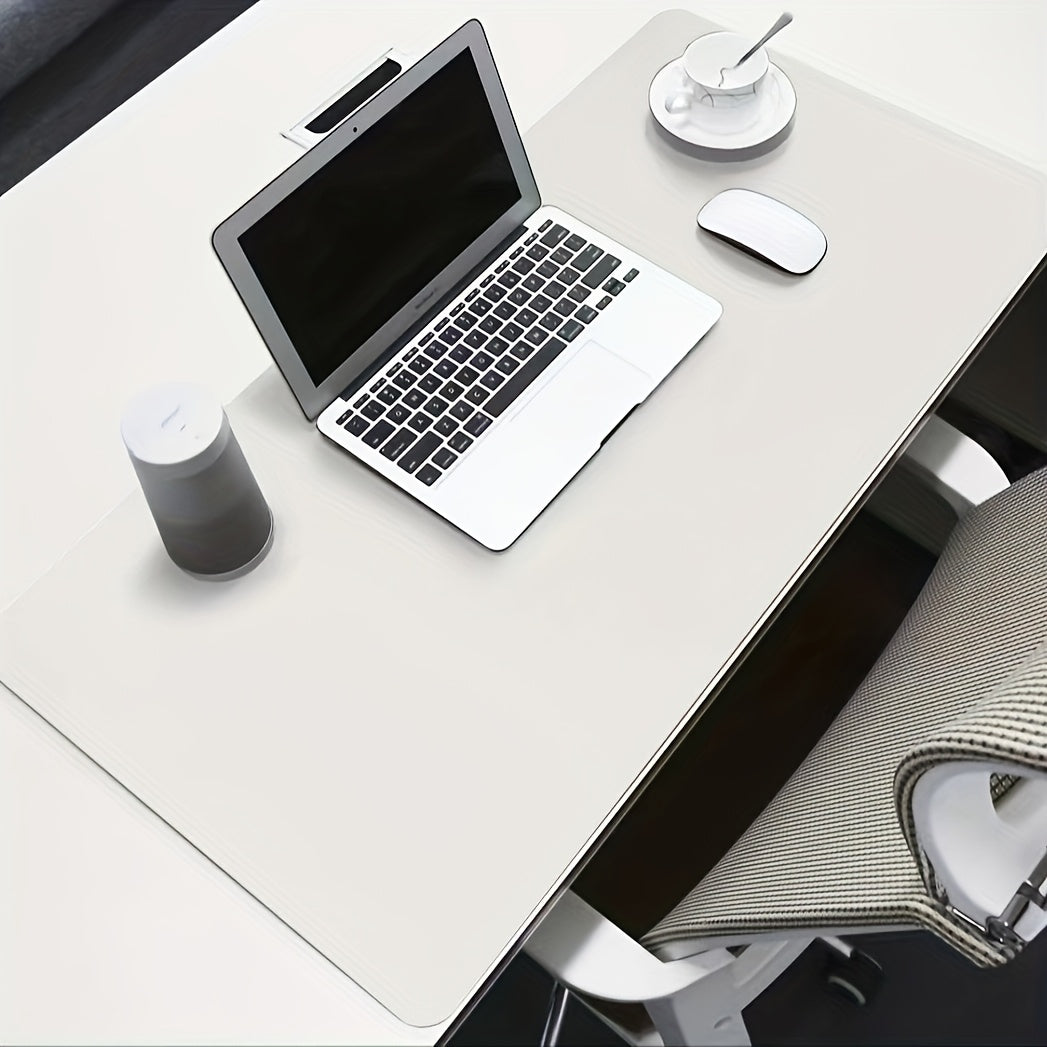 Waterproof faux leather desk pad with anti-slip surface for office and home use. Measures 59.99 x 32.99 cm. Rectangular mouse pad for workspace protection. Sleek and easy to clean design.