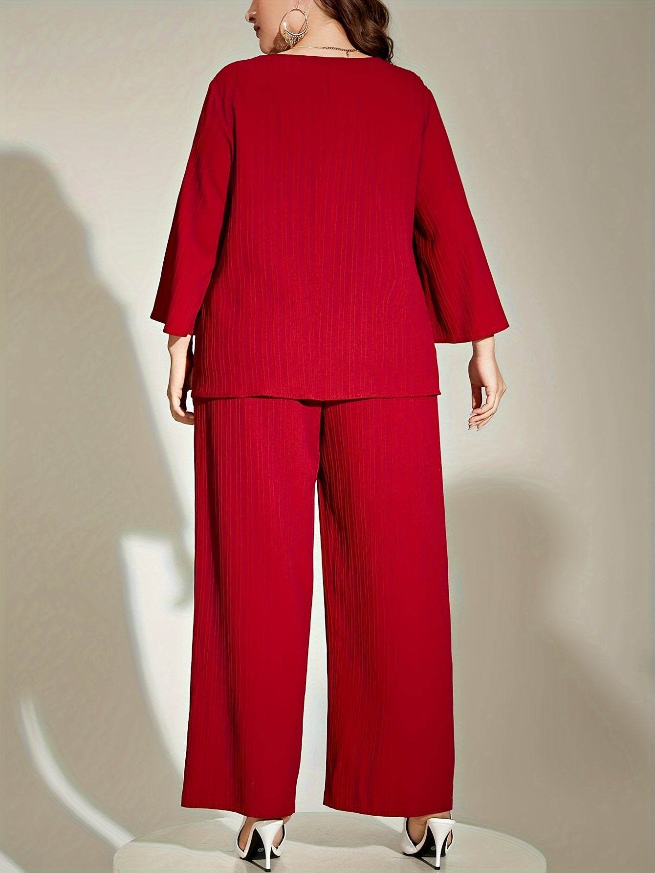 Chic red ribbed suit set for elegant plus size women, includes 3/4 sleeve top and wide-leg pants. Made of polyester, machine washable.