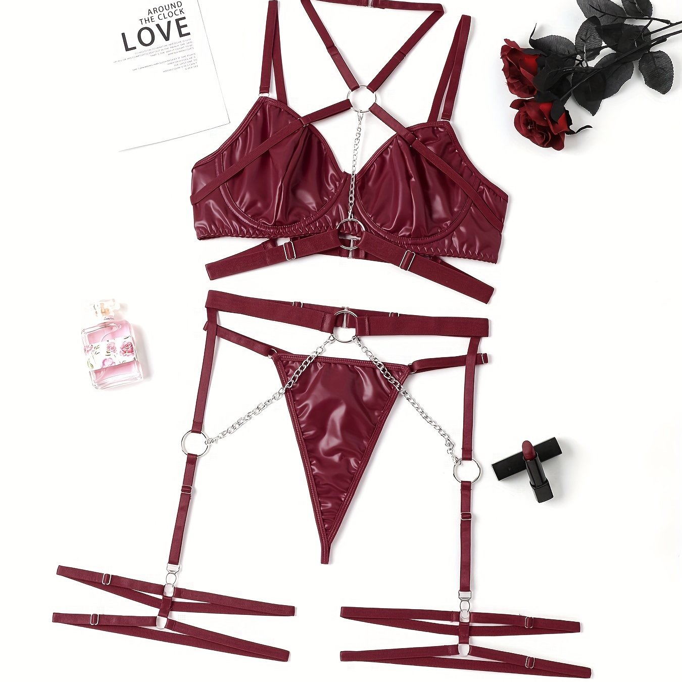 Women's punk lingerie set with ring-link strappy design, halter plunge bra, garter belt, and thong.