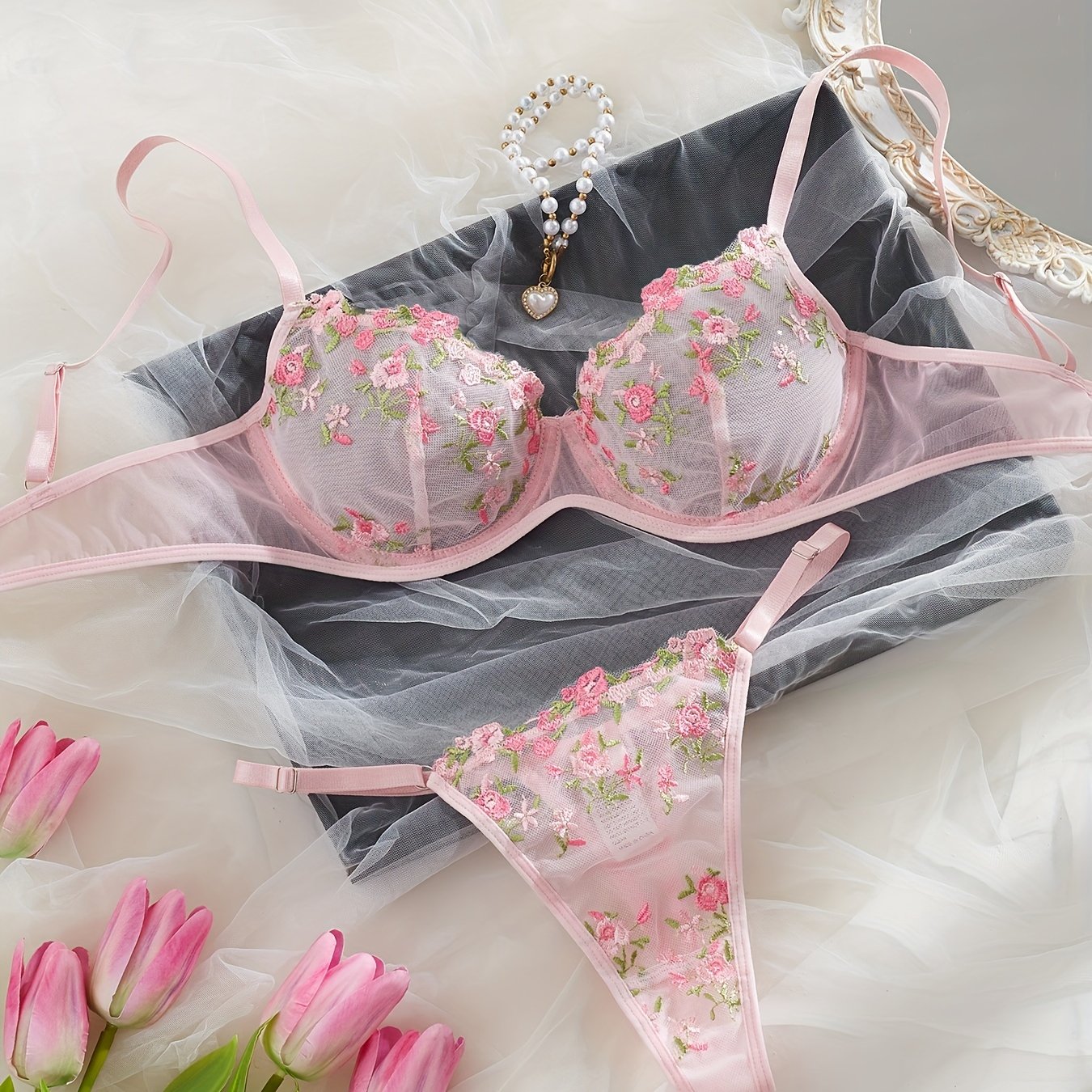 Chic French-inspired lingerie set in pink with floral embroidery and butterfly lace, featuring a sheer mesh bra and thong combo, medium support, hand wash only.