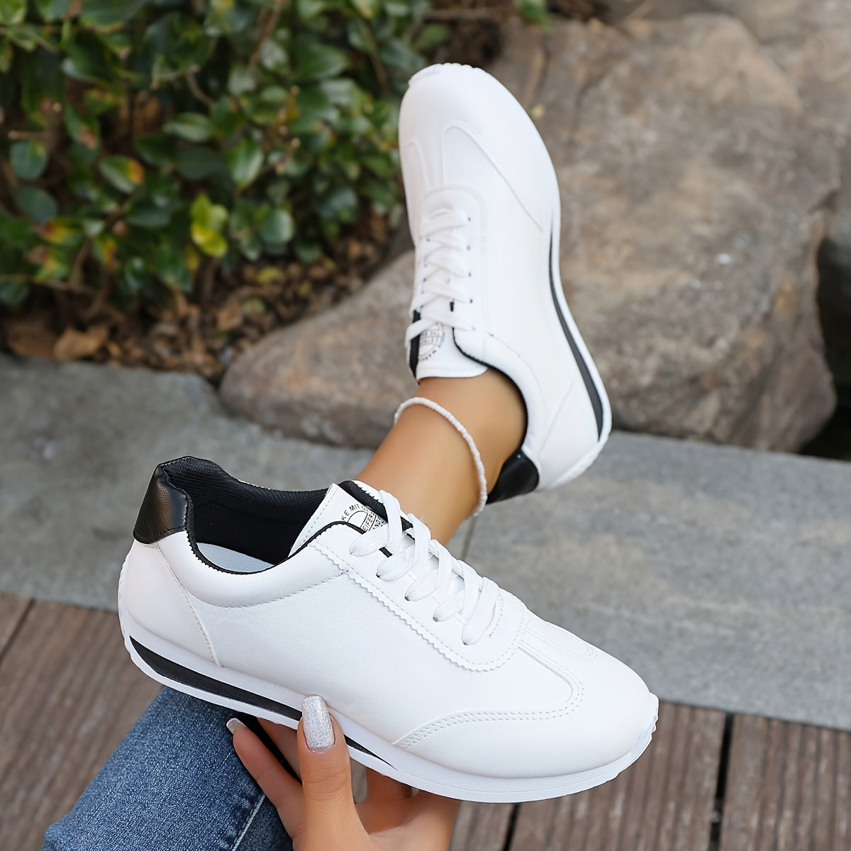 White synthetic leather women's casual sneakers with stability support, all-season comfort, and breathable fabric lining. Perfect for casual attire.