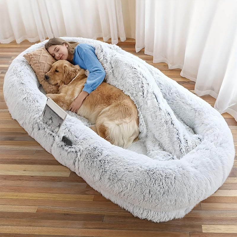 Oval-shaped plush sofa bed for dogs and people, cozy and warm with a non-slip bottom and machine washable in gray color.