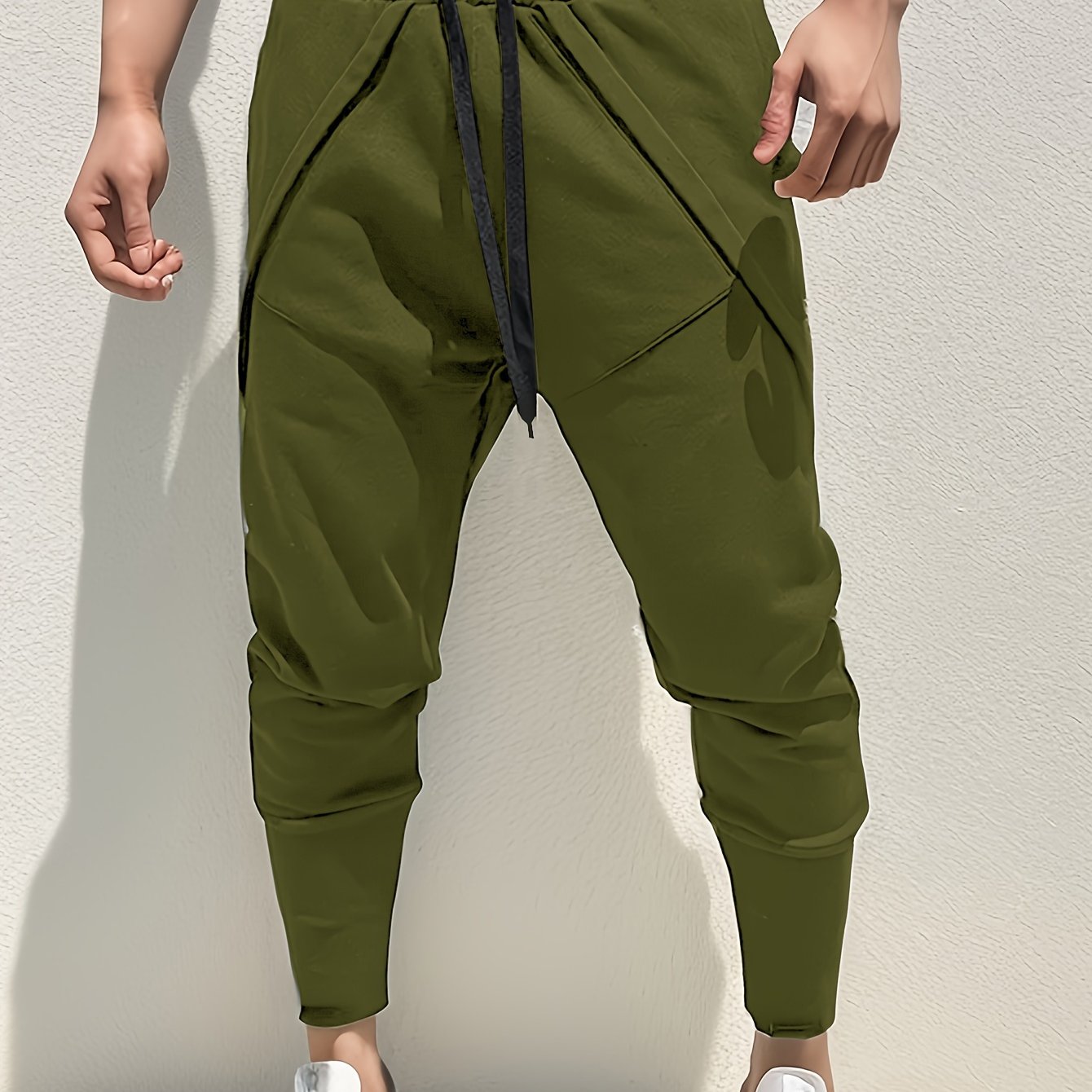 Casual style men's athletic sweatpants with tapered fit, side pockets, and adjustable drawstring for sports and relaxation.