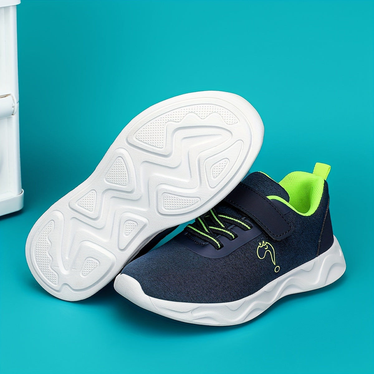 Breathable sneakers for kids with non-slip soles and hook and loop closure.