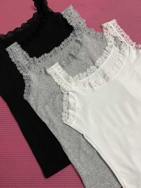 Three solid color women's tank tops with lace straps, including a versatile option for both inner and outer wear.