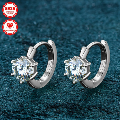 These elegant earrings feature a pair of round Mozambique stones, each 6.5mm in diameter and D color. The stones are set in a single six-prong setting with a 10mm inner diameter, crafted from 925 sterling silver. Accompanied by a GRA certificate, these