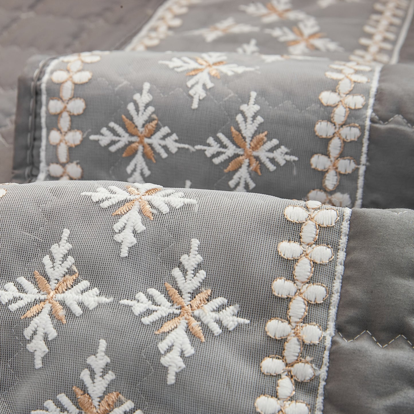 Waffle quilting sofa cover with snowflake lace decor and anti-slip backing.