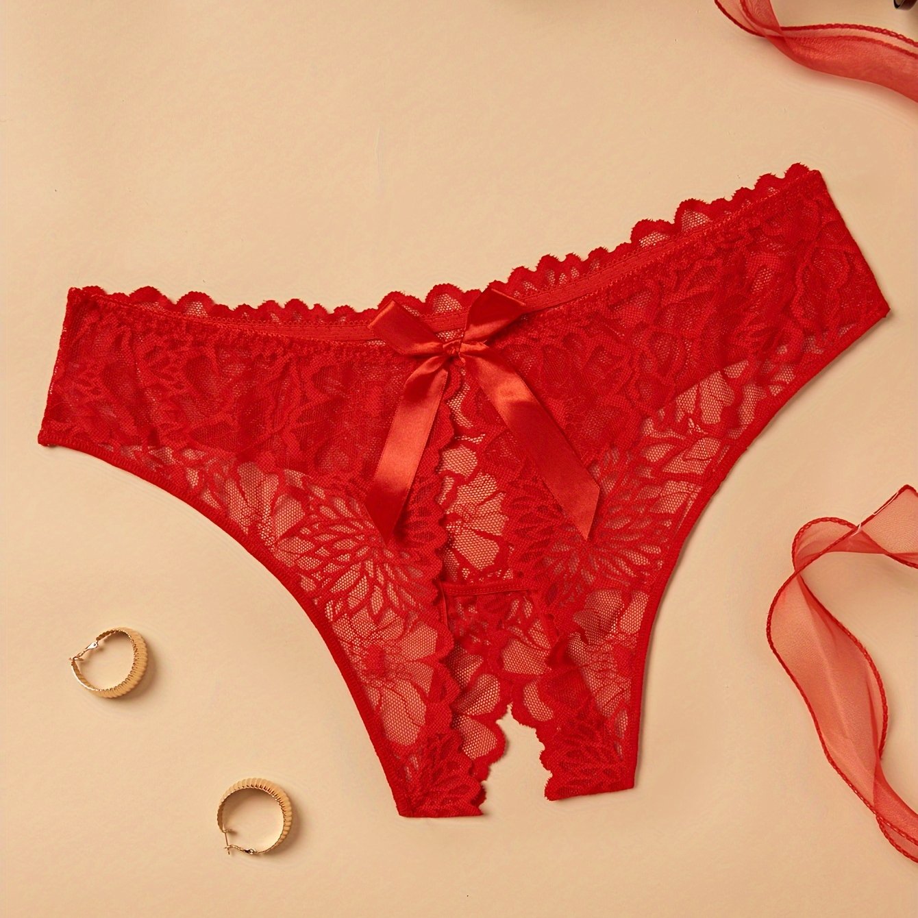 Plus size lace thong panties for women with back bow detail, made of nylon for a comfortable fit.