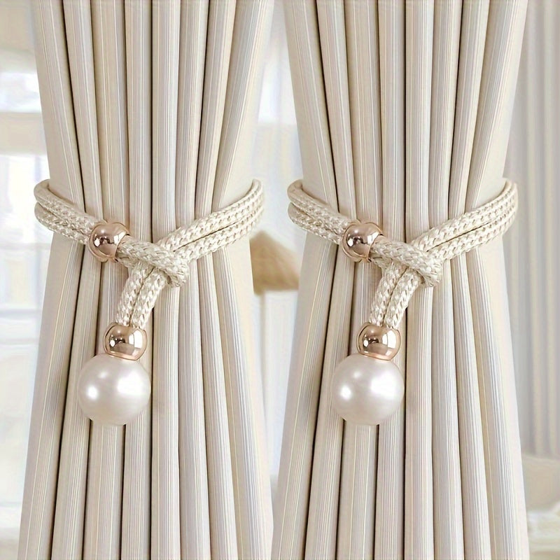 A faux pearl curtain tieback, perfect for holding back your living room curtains and adding a touch of elegance to your home or office decor. This decorative accessory is a stylish way to keep your curtains neatly stored when not in use.