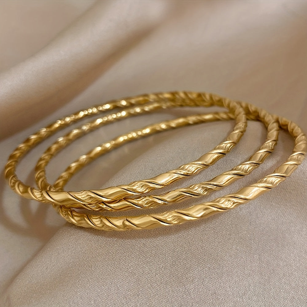 Set of 3 Golden Twist Stainless Steel Bangles, featuring a Chic Classic Tibetan Buddha design. Can be stacked for a stylish look, perfect for both women and men.