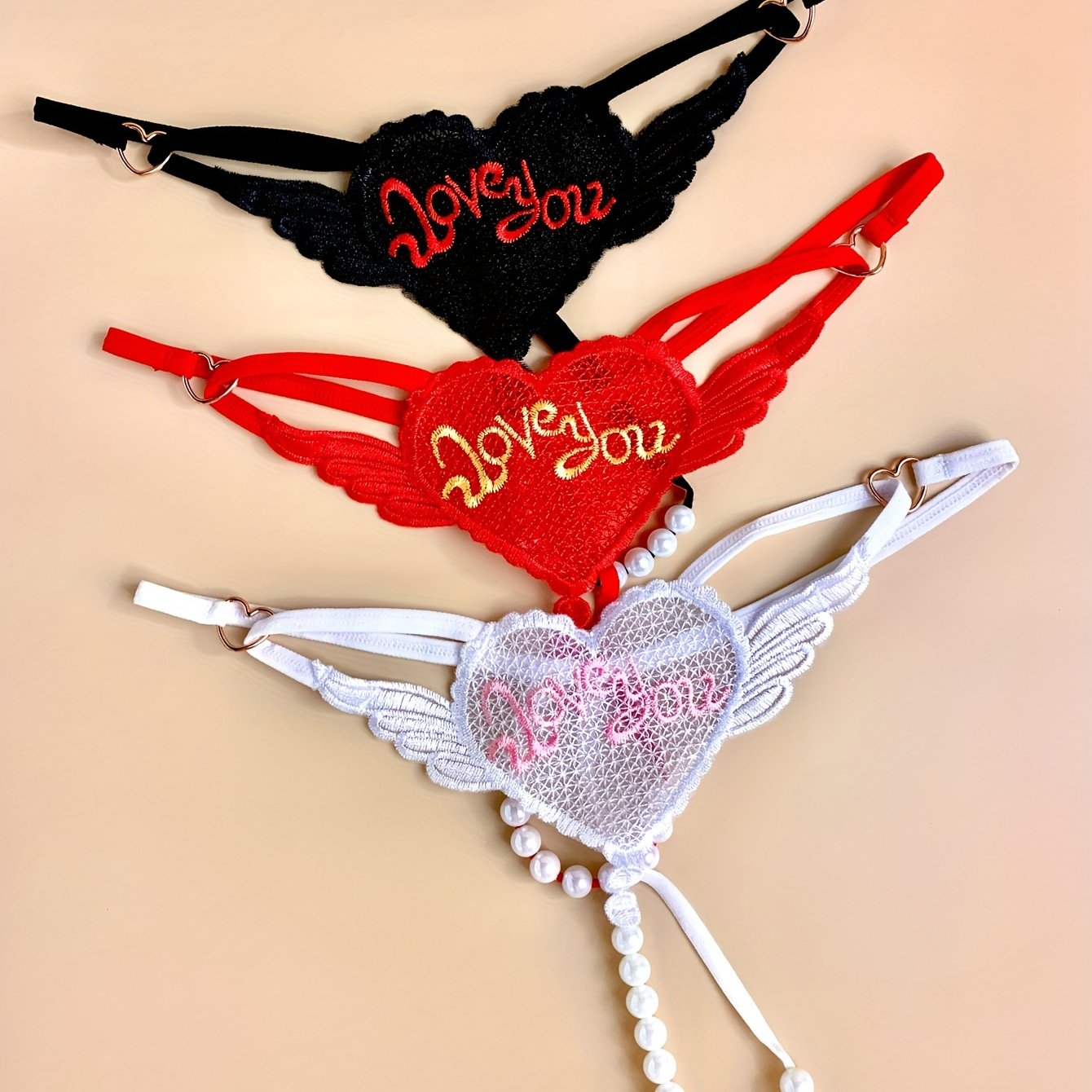 3 Elegant heart chain thongs with 'LOVE YOU' embroidery, perfect for Valentine's Day. Made from soft polyester and spandex blend.