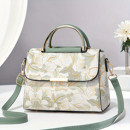 Large capacity floral embroidered crossbody bag with zipper closure and polyester lining. Versatile commuter handbag with luxurious, fashionable design and edge paint detail. Available in