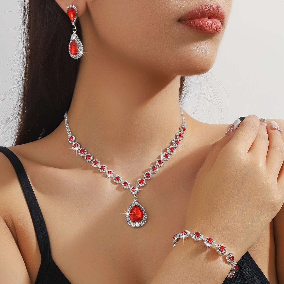 A set of three jewelry pieces for brides and ladies, including one necklace, one pair of earrings, and one bracelet, all featuring flower drop designs. Perfect accessories to complement any dress.