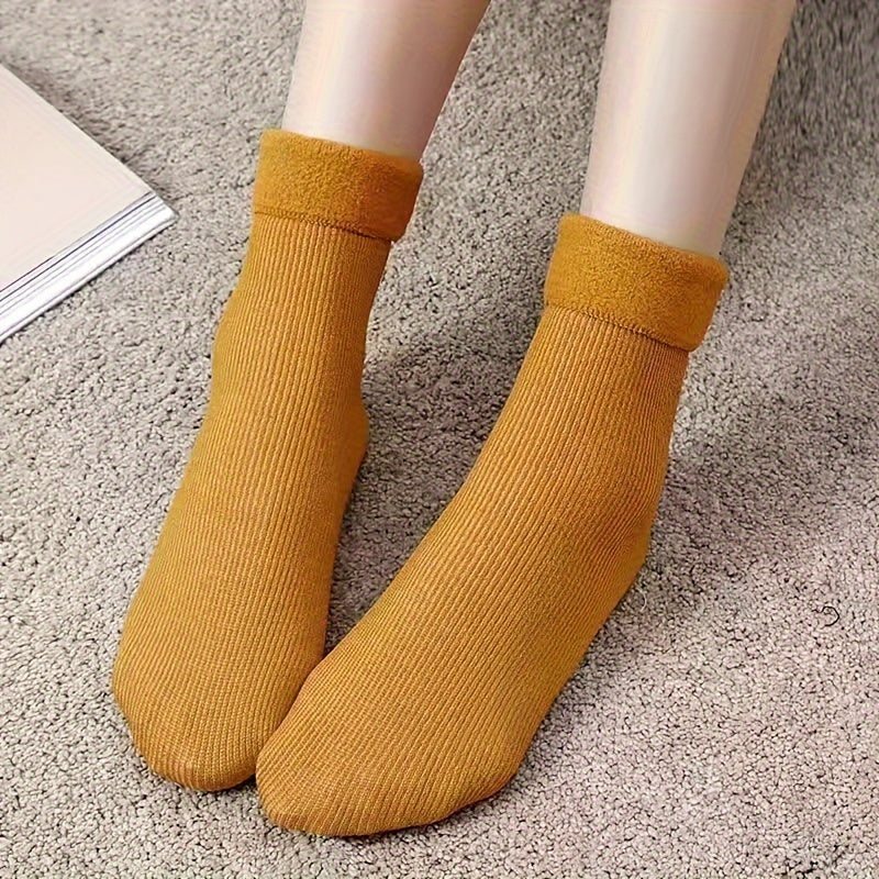 4 pairs of cozy thermal snow socks perfect for winter, lined with fleece for extra warmth, great for casual wear.