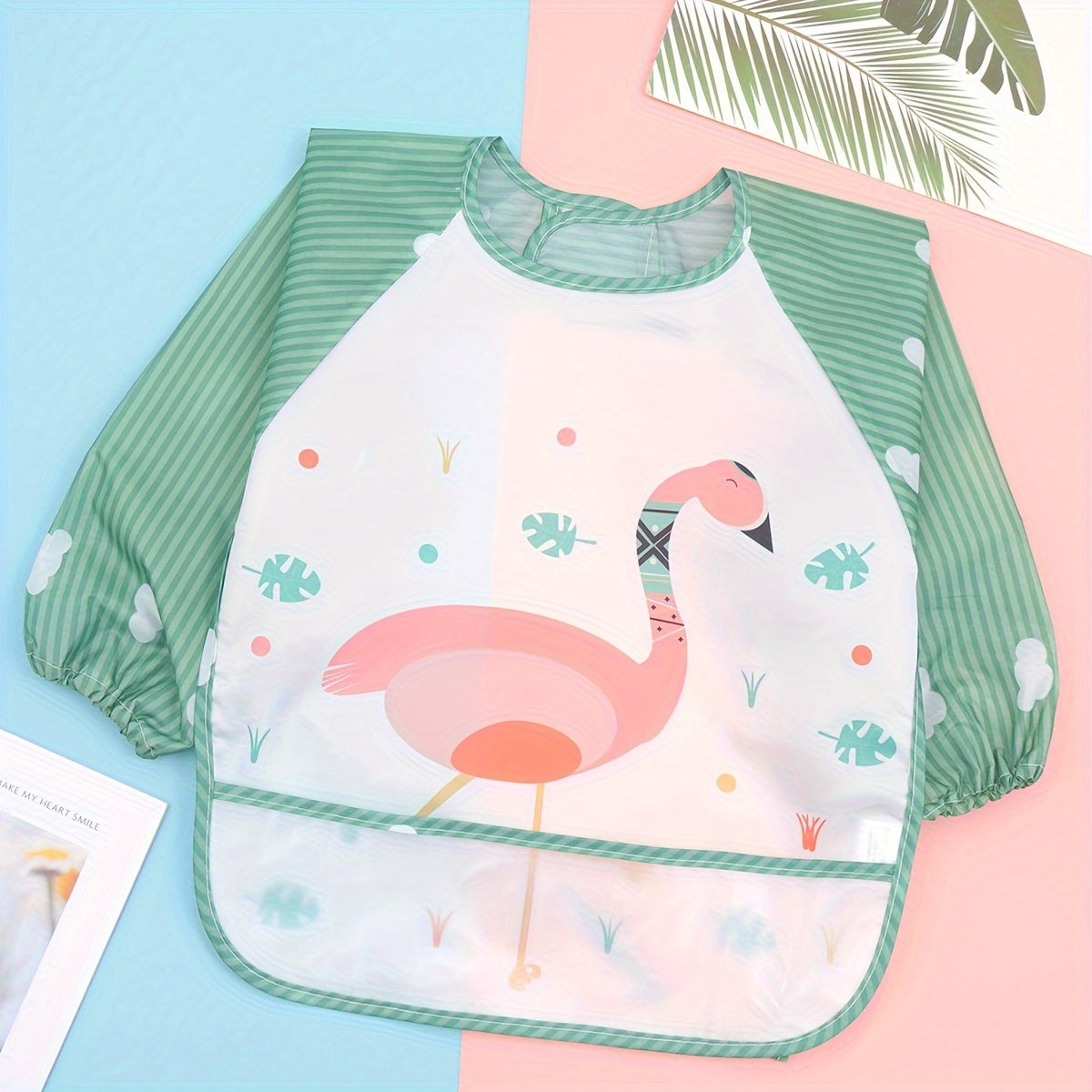 Easily cleanable reverse wear cartoon bib with waterproof long sleeves, suitable for home and travel.