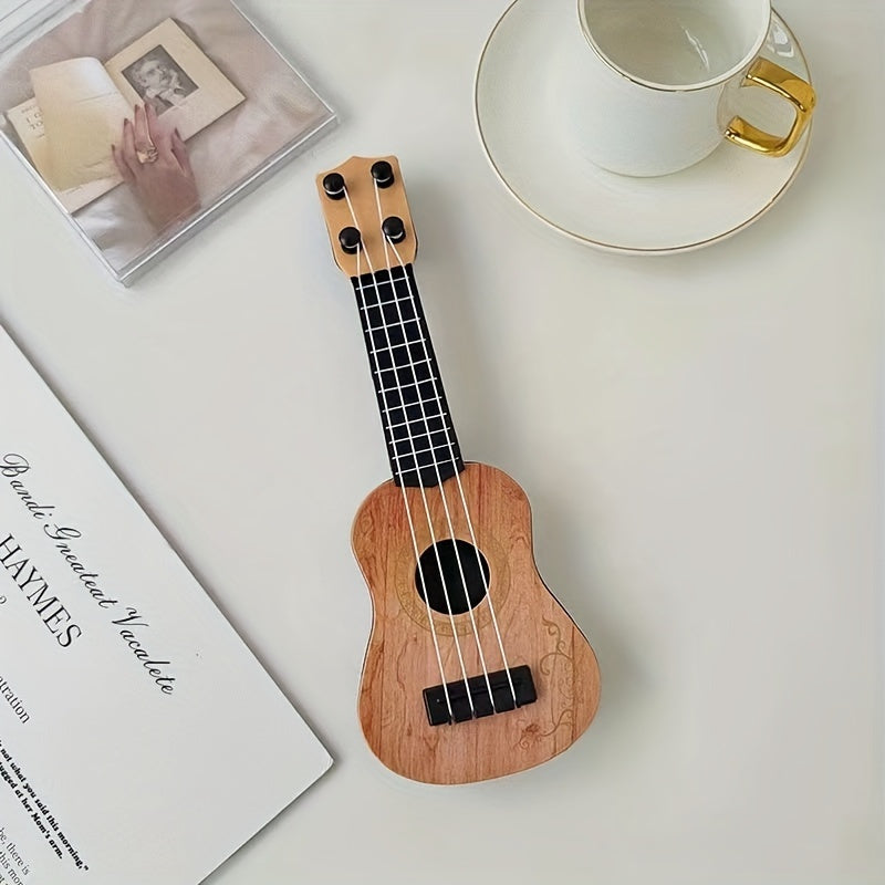 Mini playable uke instrument figurine made of plastic for home and office decor, ideal gift for music enthusiasts.