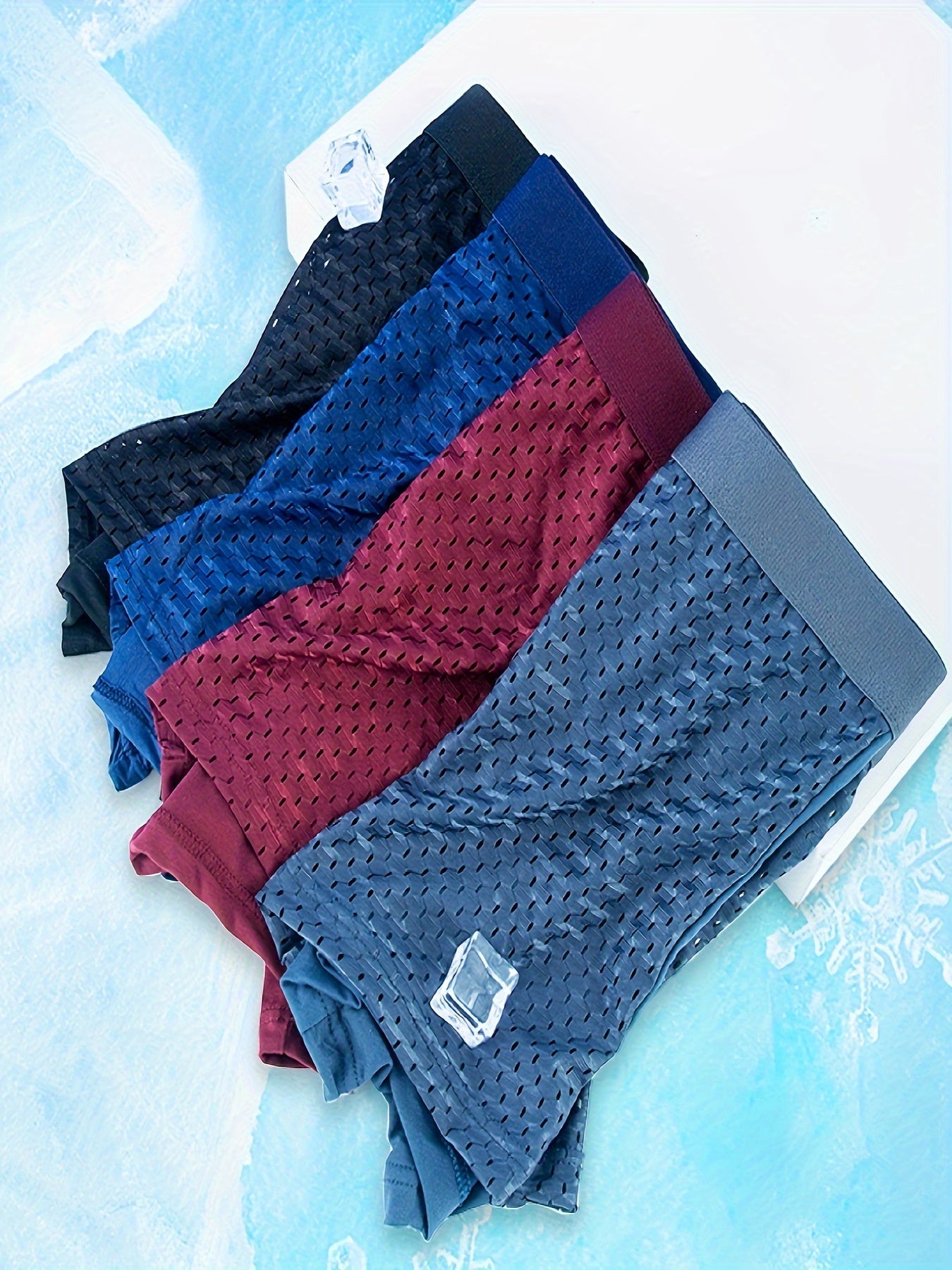 10 assorted men's mesh boxer briefs in navy, dark blue, charcoal, & burgundy with elastic waistband & metal fasteners.