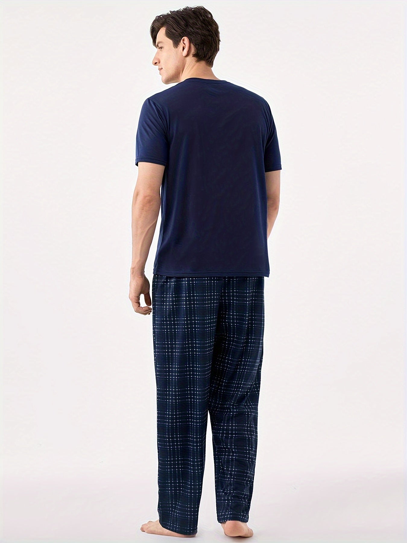 Men's blue pajama set with classic round neck, short sleeves, and plaid trousers for cozy loungewear.