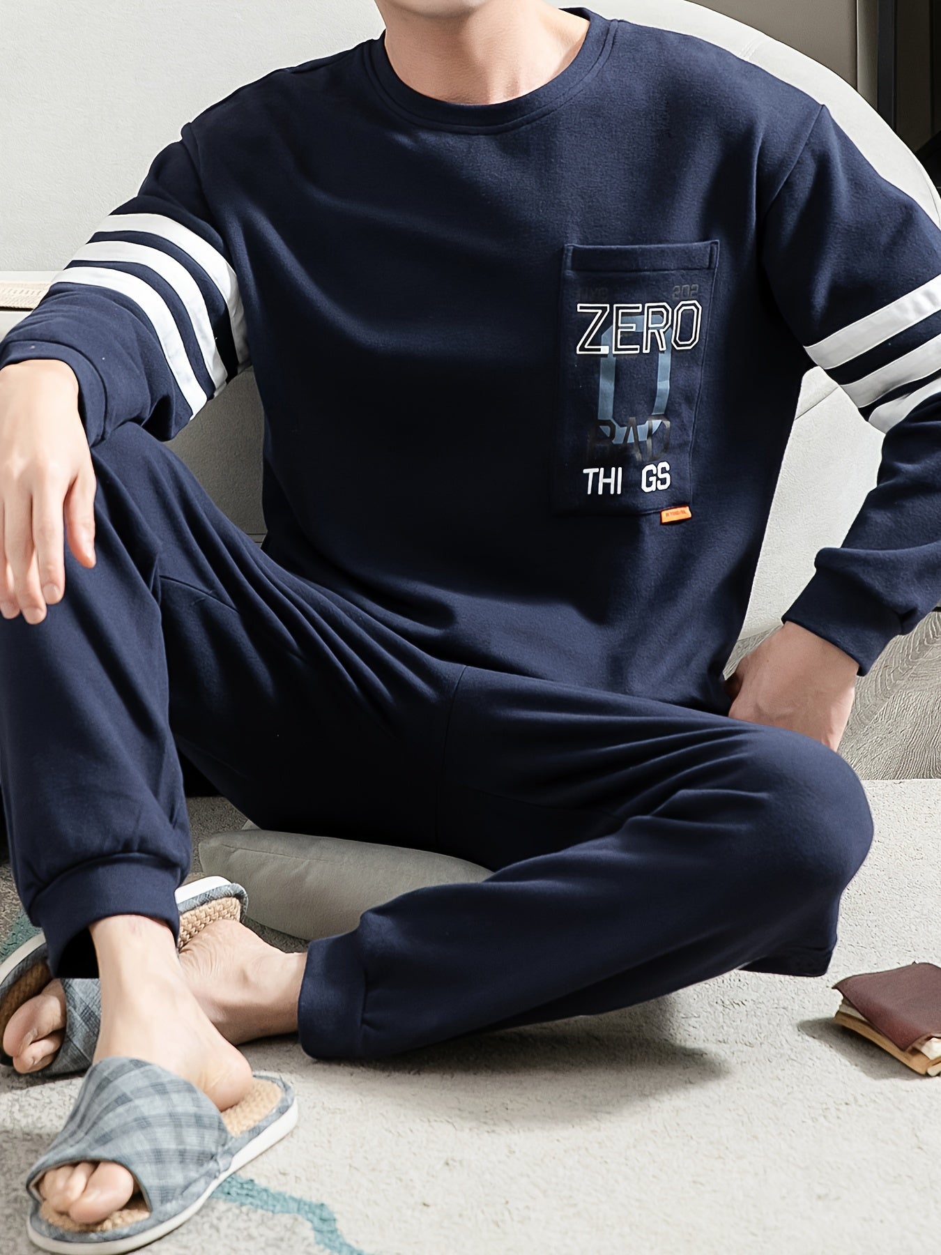 Casual cotton pajamas set for men with letter graphic print, long sleeve crew neck top with chest pocket and loose pants. Suitable for spring and autumn.