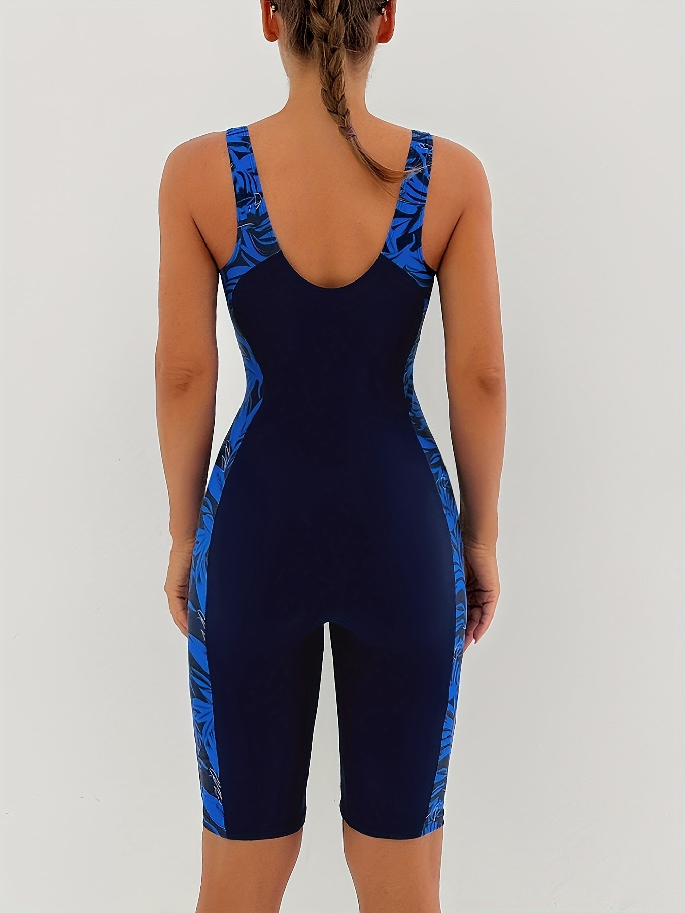 Women's one-piece swimsuit with high stretch, scoop neck, removable pads, knit polyester fabric, and random print design.