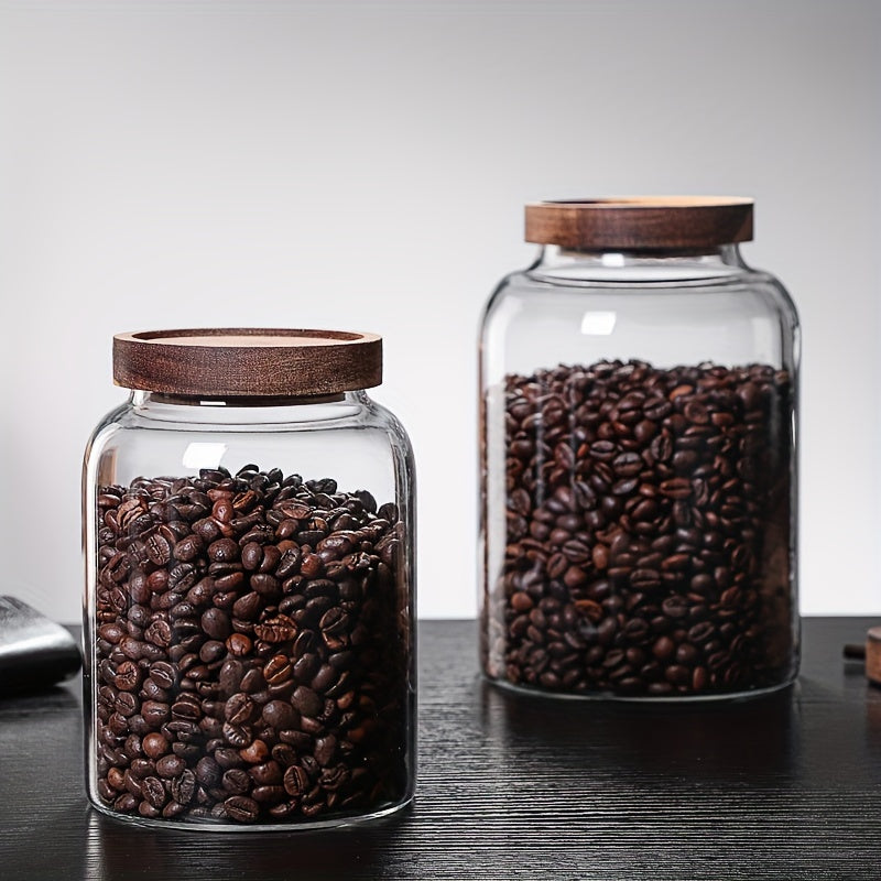 Large glass food storage jars with airtight wooden lids for storing coffee beans, dried food, pasta, tea leaves, overnight oats, grains, and spices. These clear glass canisters are perfect for organizing your kitchen and keeping your ingredients fresh.