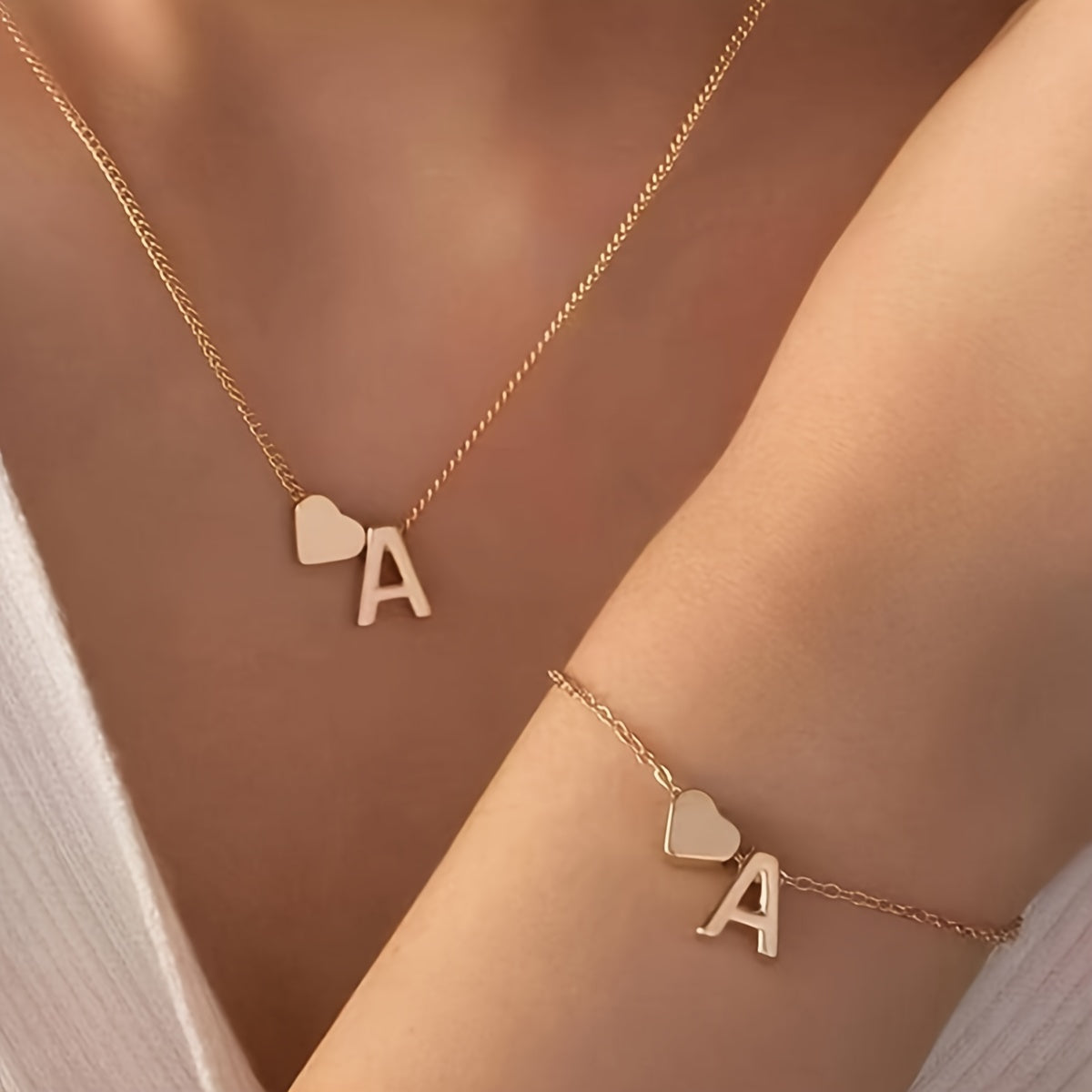 Chic two-piece set with metal heart and letter necklace and bracelet, ideal for daily wear.