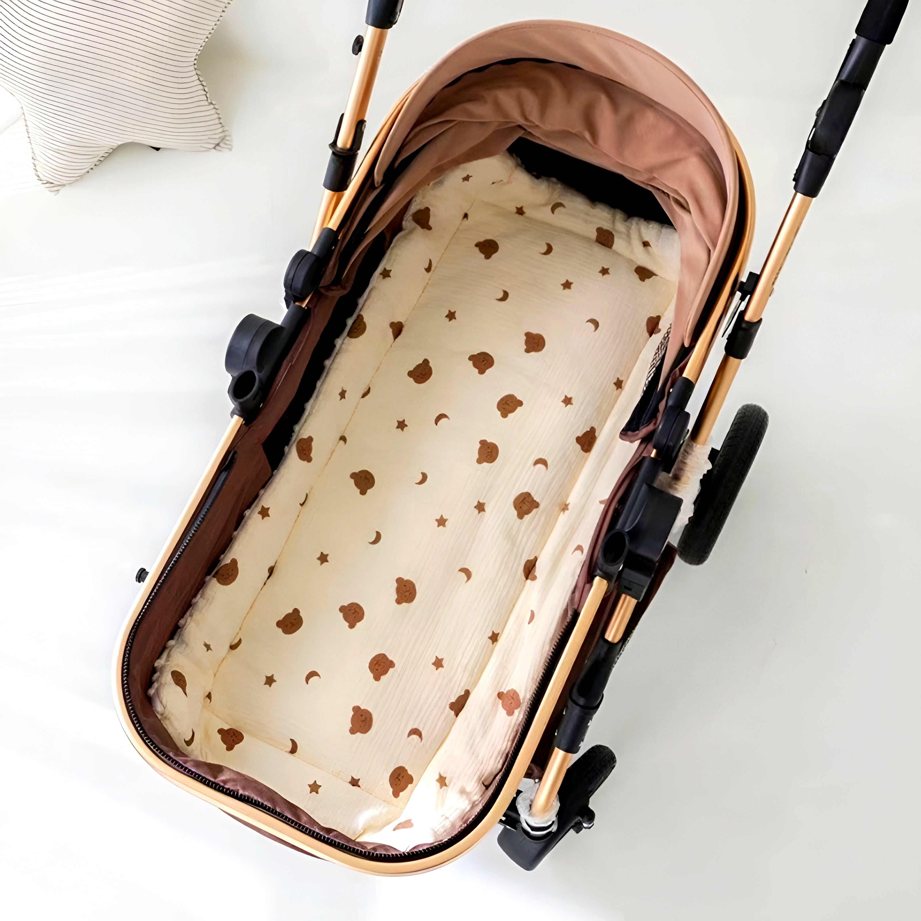 Thick double-sided cotton pad in beige for stroller, featuring a moon bear design. Machine washable and soft stroller mat.