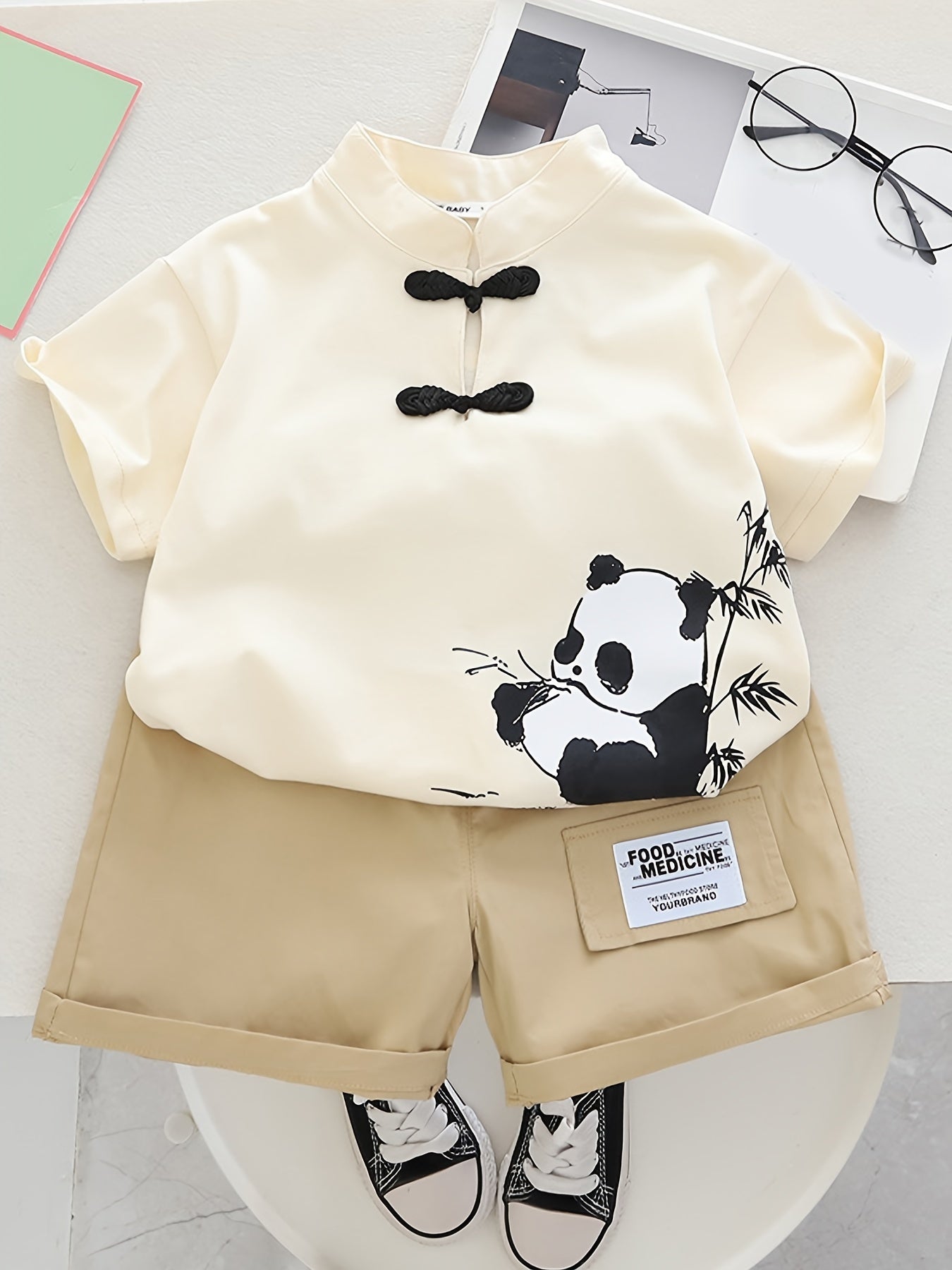 Cute panda cartoon summer outfit for kids - comfy short sleeve top and shorts set, made of breathable polyester blend, ideal for outdoor activities.