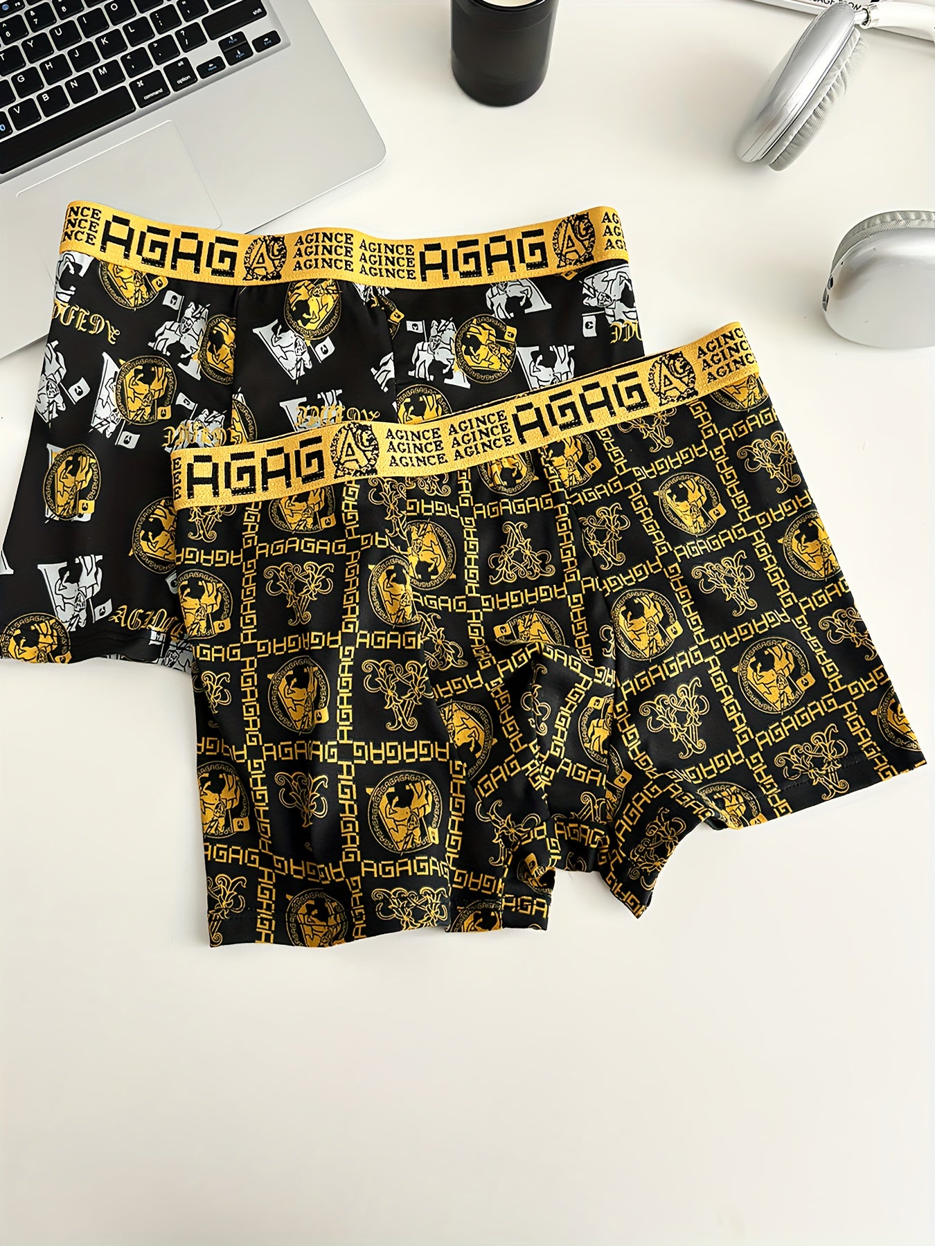 2-Pack Men's boxer briefs with golden print, made of 95% polyester and 5% spandex. Features stretchy knit fabric, geometric pattern, and breathable, quick-drying material for durable daily