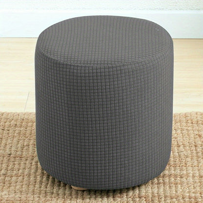 Stretchable round footstool cover made from soft polyester blend with elastic fit. Available in multiple colors, machine washable, modern design for living room ottomans.