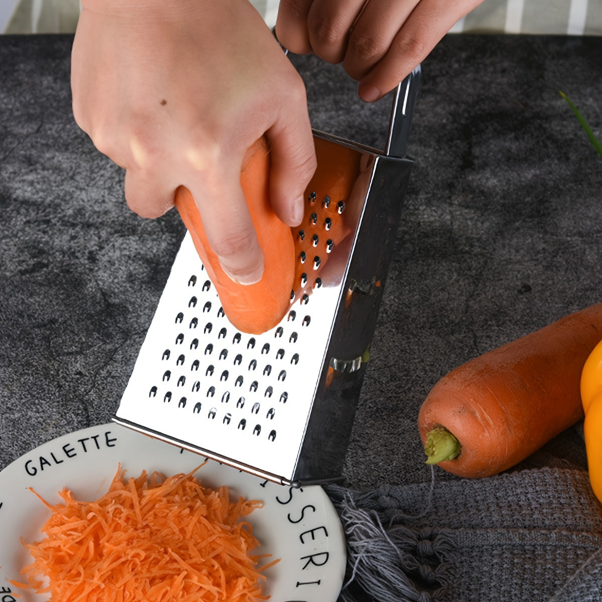 Upgrade your kitchen with the Stainless Steel 4-Sided Box Grater - a versatile tool for grating cheese, vegetables, and potatoes. This multifunctional grater features a non-slip handle for easy use.