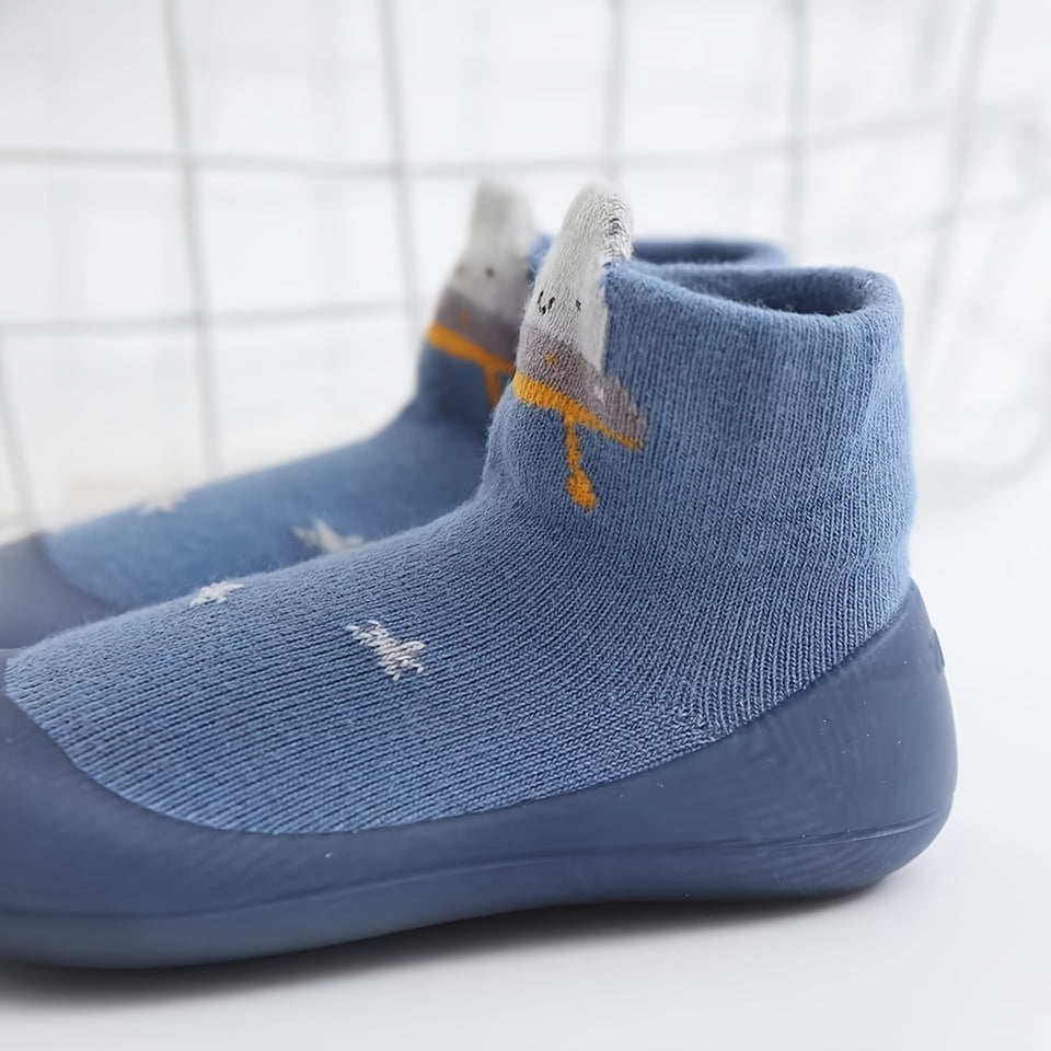 Cute lion cartoon slip-on sock shoes for baby boys in light blue with yellow accents. Soft, breathable, and non-slip rubber sole, perfect for first walkers in spring and fall.