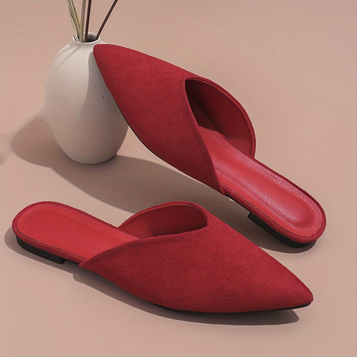 Stylish orange flat mules for women in plus sizes with pointed toe and slip-on design, perfect for casual wear.