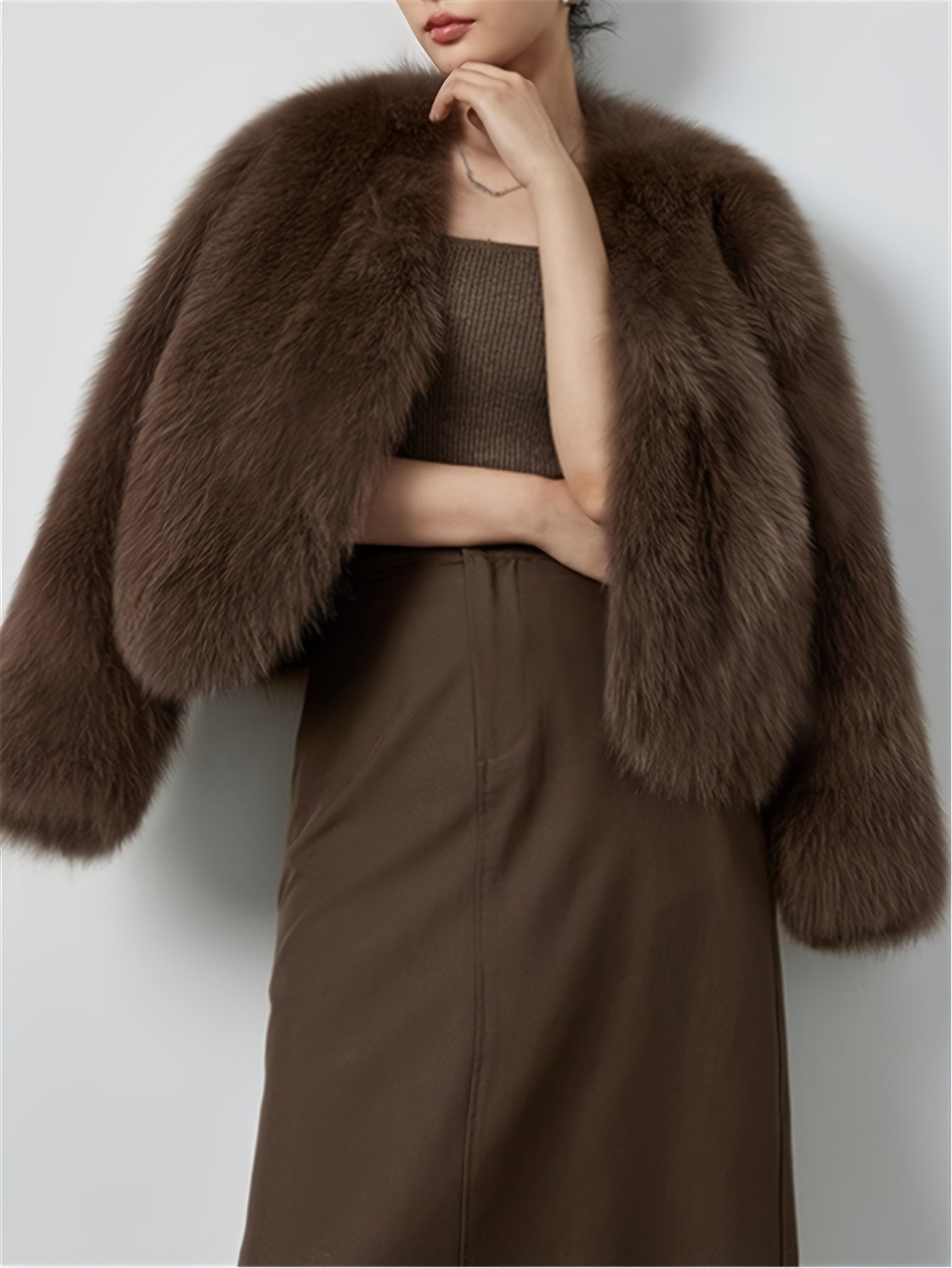 Elegant faux fur trim jacket in light beige/blonde for women. Made of soft polyester material, perfect for cold weather. Features a chic style with long sleeves and classic collar design.