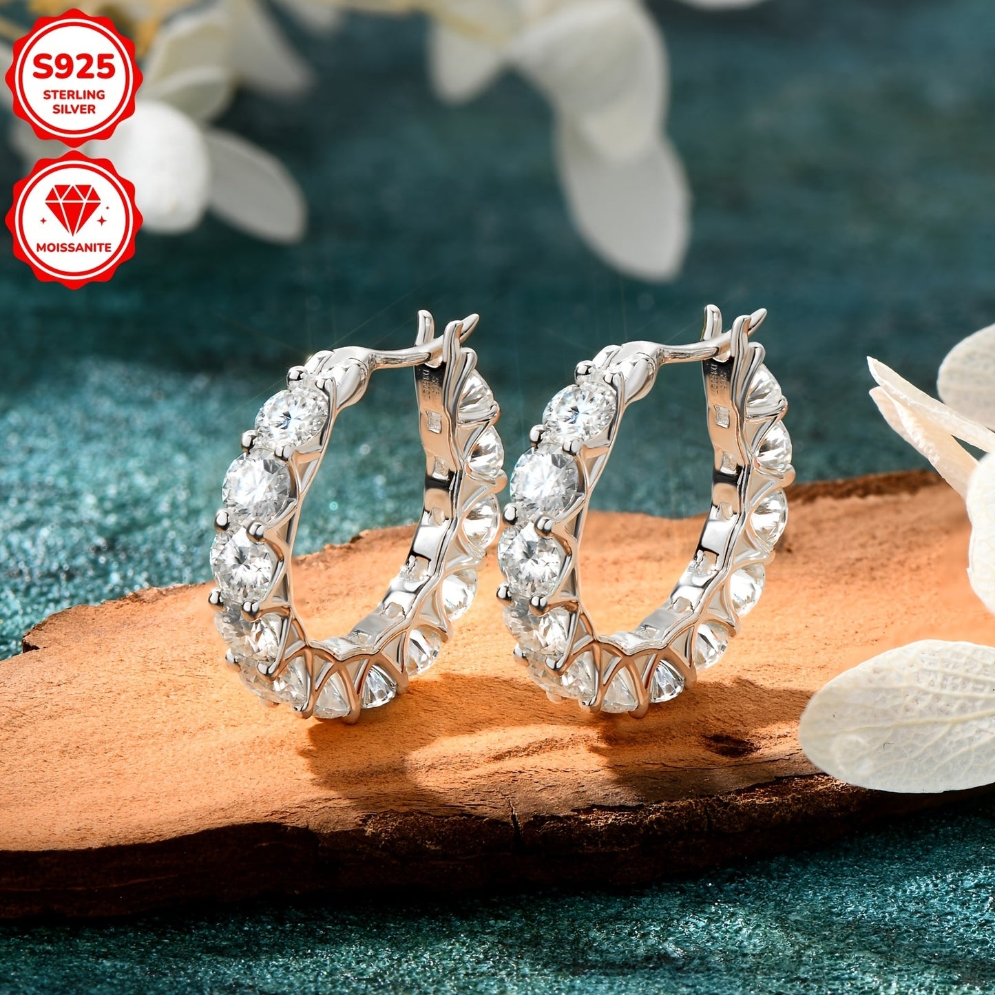 A pair of stunning Moissanite earrings crafted in 925 sterling silver feature a full circle round design with 3mm and 4mm Moissanite stones. The row set earrings have an inner diameter of 13mm, making them the perfect addition to any jewelry collection.