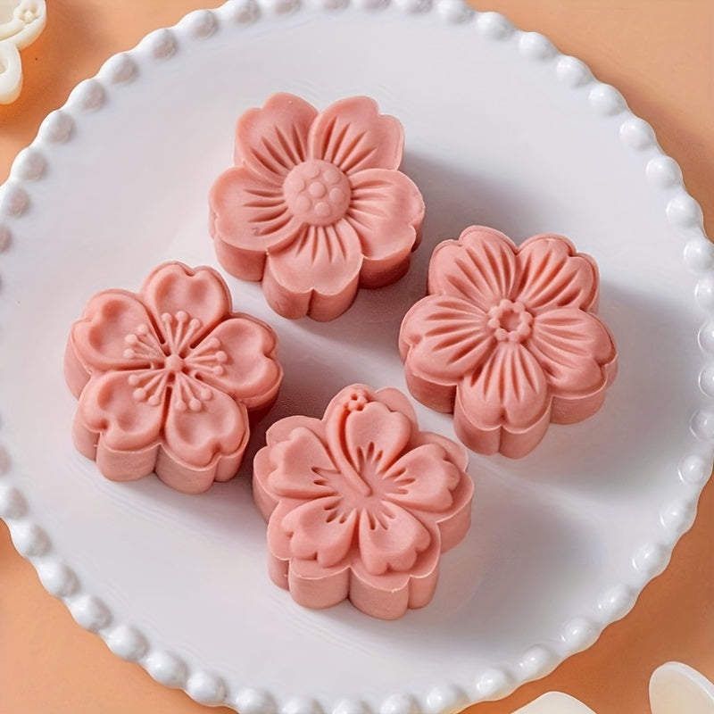 Set of 4 plastic mooncake embossing molds with blossom design for baking and crafting desserts.