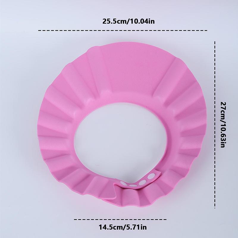 Adjustable baby shampoo cap in pink and yellow, made of soft polyester, protects eyes and ears during hair washing. Ideal for bathing and hair care.