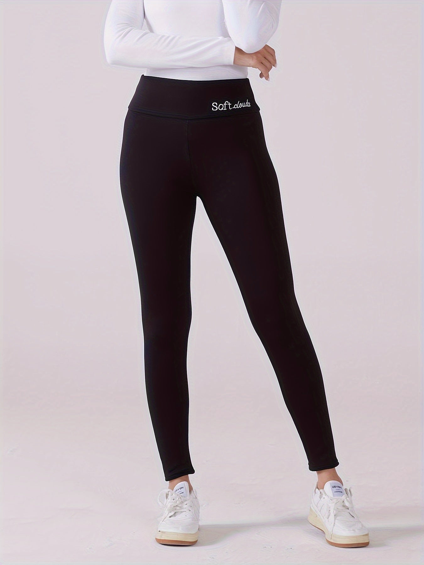 Cozy high-waist leggings with fleece lining, embroidery, and stretchy polyester blend for elegant autumn and winter comfort, machine washable.