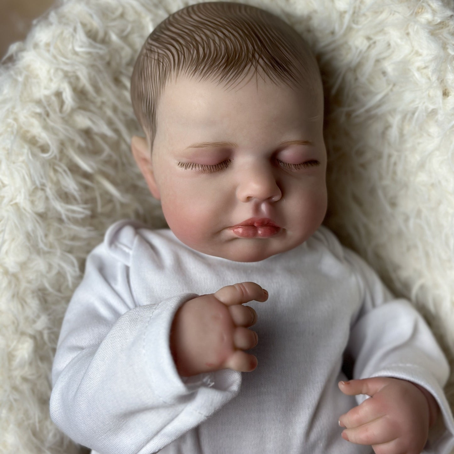 Realistic 20-inch Reborn Baby Doll with soft vinyl limbs, cloth body, and lifelike features.