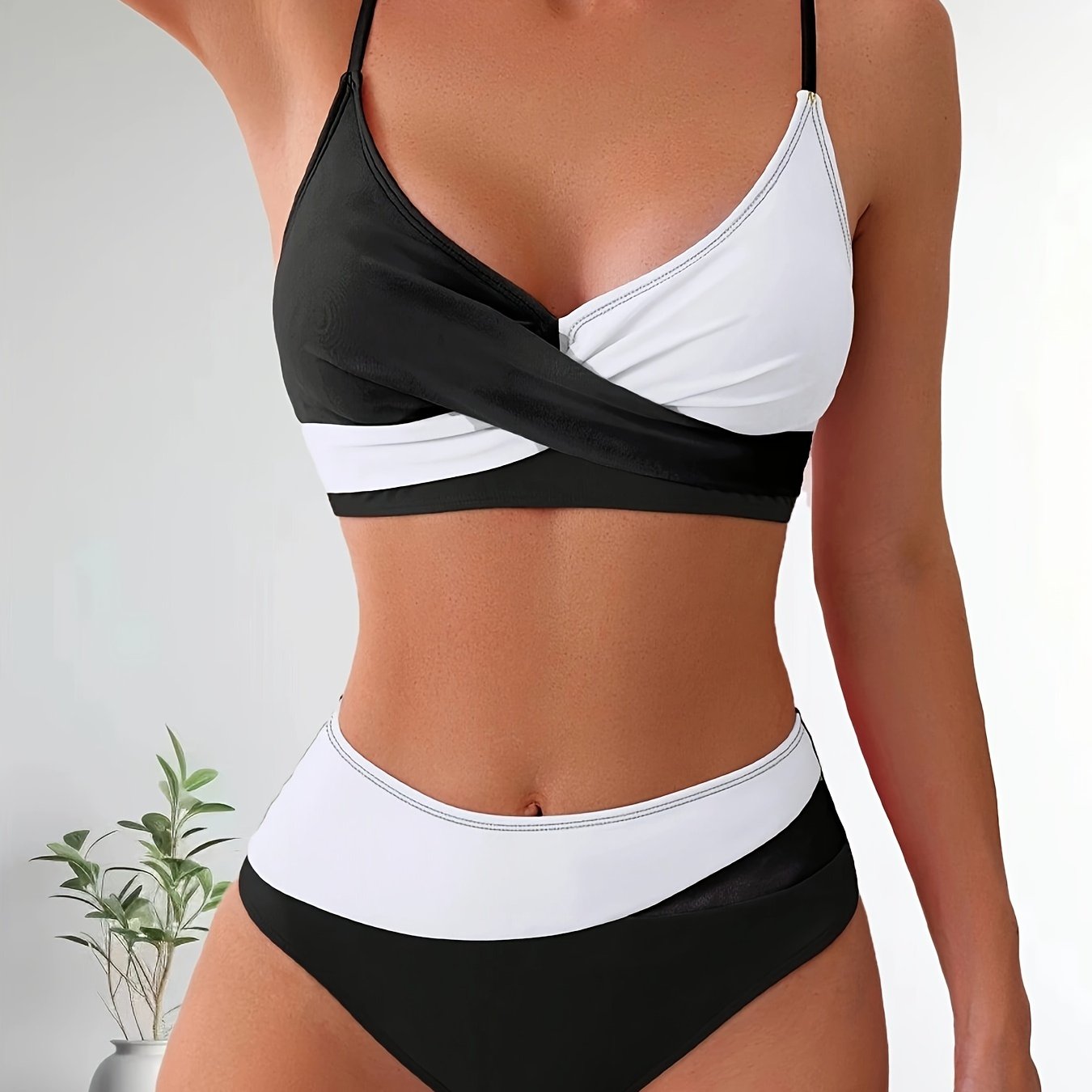 Patchwork two-piece swimsuit with crossed colors and high-waisted design.