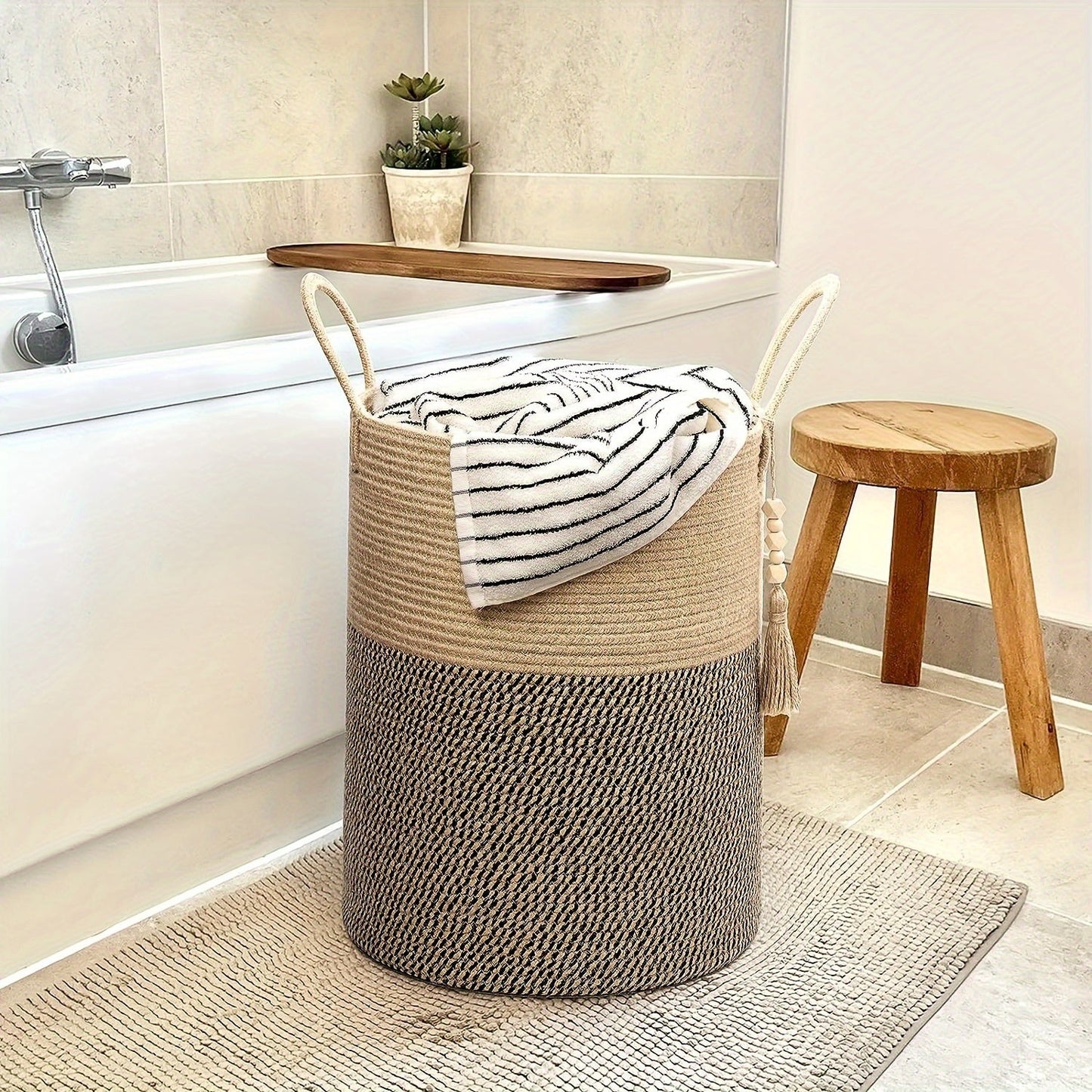 This tall laundry basket measures 40.64cm X 50.8cm and features a woven design with a convenient handle. It can be used as a blanket organizer in the living room, a storage basket for dog toys, or a decorative jute laundry hamper for clothes, pillows